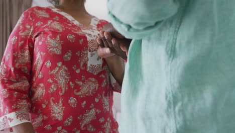 African-american-couple-holding-hands-at-home.-Social-distancing-in-quarantine.