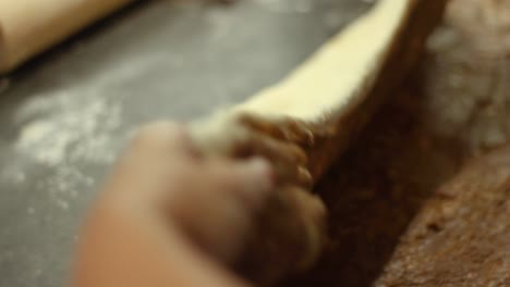 woman folding cinnamon bun batter