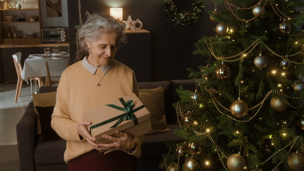Senior Woman Holding Christmas Gift