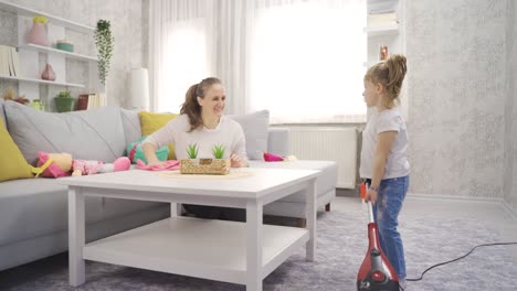 mother daughter love. mother and little girl cleaning house.