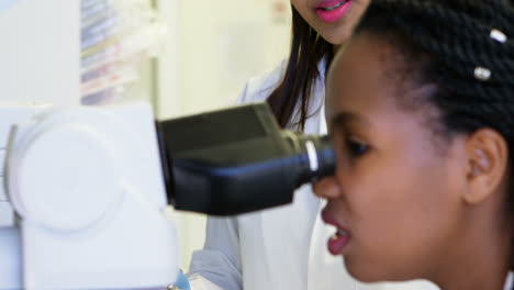 scientist looking through microscope 4k