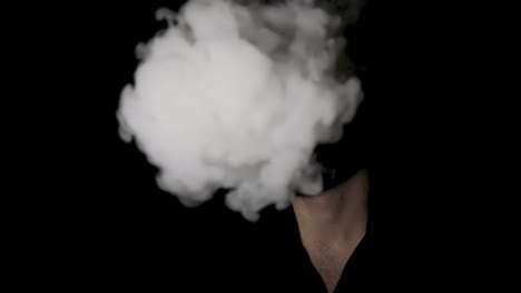 man disappearing behind cigarette smoke, black background