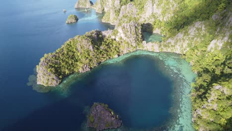 tropical seascape of karst rock cliffs and blue lagoons in coron, aerial