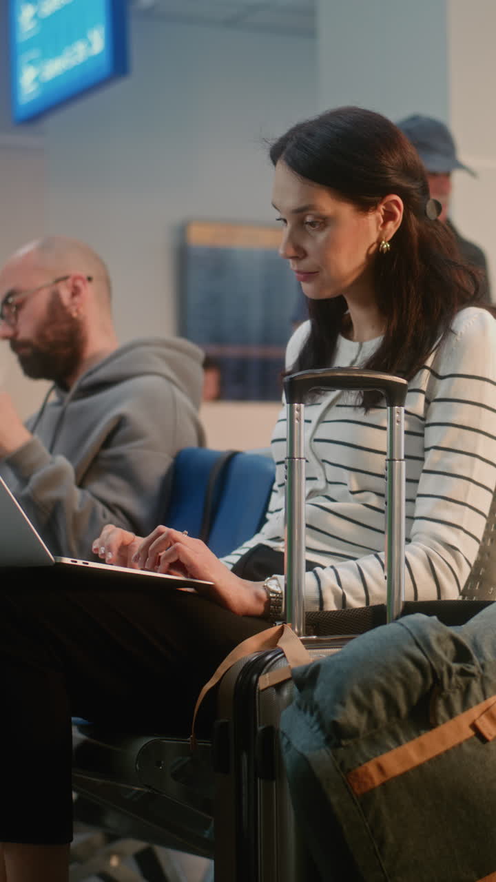 Woman working on laptop at the airport