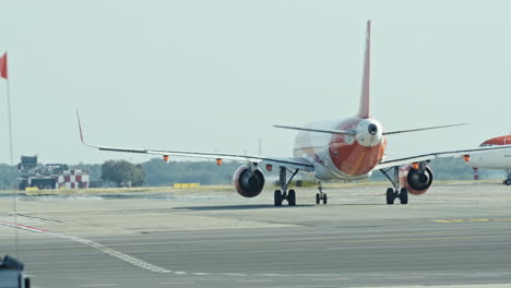 a commercial airplane taxis on the runway, preparing for takeoff during a bright day