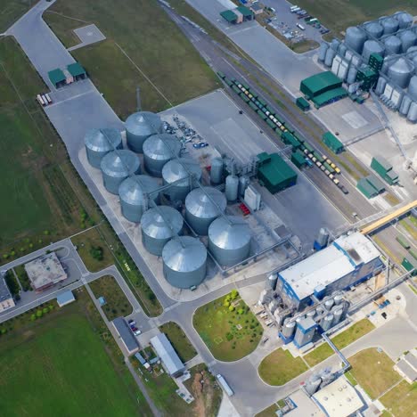 grain elevators on field. modern plant for agricultural business. large metal silos of grain-drying complex. top aerial view