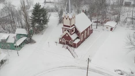 beautiful church amidst snowfall aerial 4k