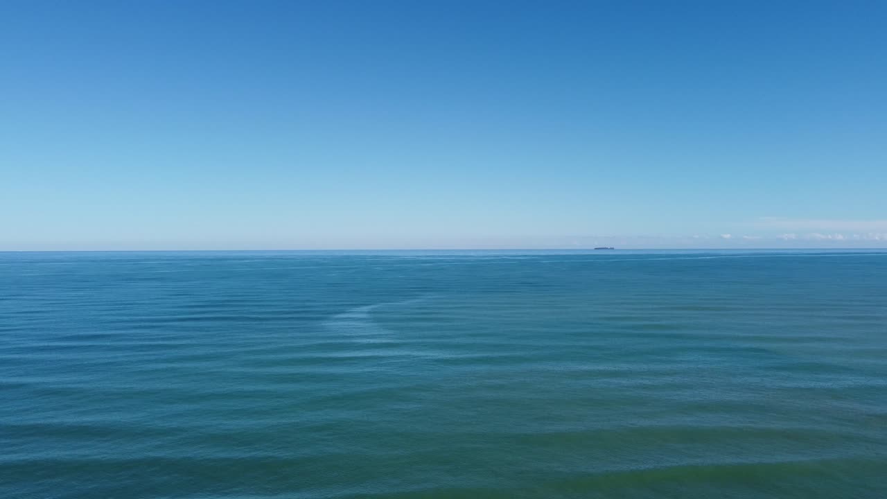 4K Aerial Drone Over Calm Mediterranean Sea with Cargo Ships and Clear Blue Sky in Spain