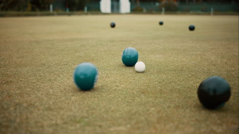 Green,-balls-and-game-of-lawn-bowling-on-grass