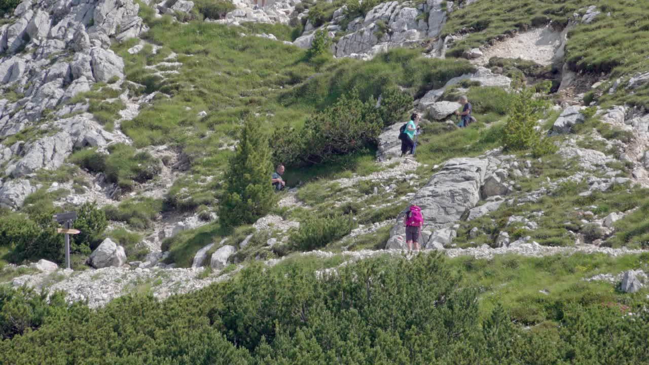 Hikers enjoying a nice day whilst heading up towards the summit of Mount Weisshorn - Corno Bianco, South Tyrol, Italy