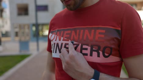 a man installs a microphone on his chest, preparing for video production and ensuring high-quality audio capture