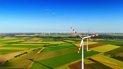 turbines on green hills under blue. a view features multiple wind turbines against a backdrop of vibrant green fields and a clear blue sky