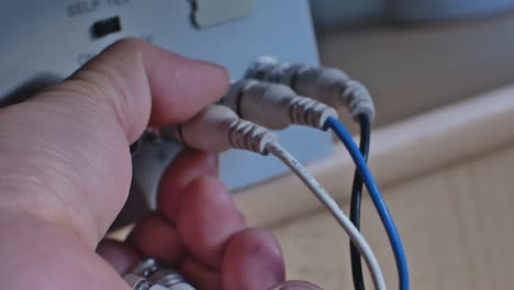 close up of disconnecting wires with old type connectors from crt monitor