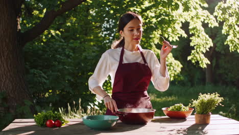 a woman prepares healthy food outdoors in a sunlit garden