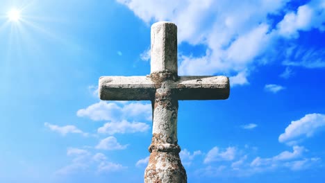 a cross made of rock with a cloud timelapse background in a blue sky