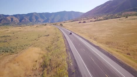 drone chases a side-by-side on a lonely desert road up into the valley