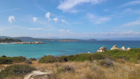 Ascending-clip-over-an-exotic-beach-in-Vourvourou,-Haklidikin-in-northern-Greece-on-a-clear-summer-day