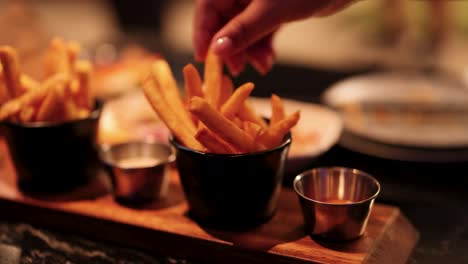 dipping fries into sauce at a driving range