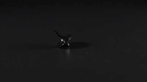 a spinning top gradually slows down