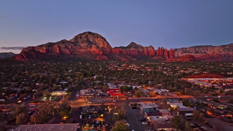 wide cinematic twilight drone shot of sedona arizona with the airport mesa mountain in the distance