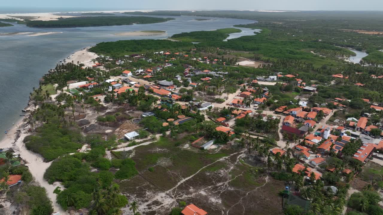 Aerial shot of Lençóis Maranhenses, Brazil, showcasing the stunning dunes and vast stretches of water reaching the horizon. The scene captures the natural beauty and unique landscape of the region.