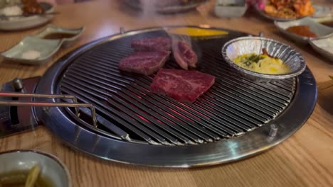 close-up of meat cooking on a hot korean barbeque grill