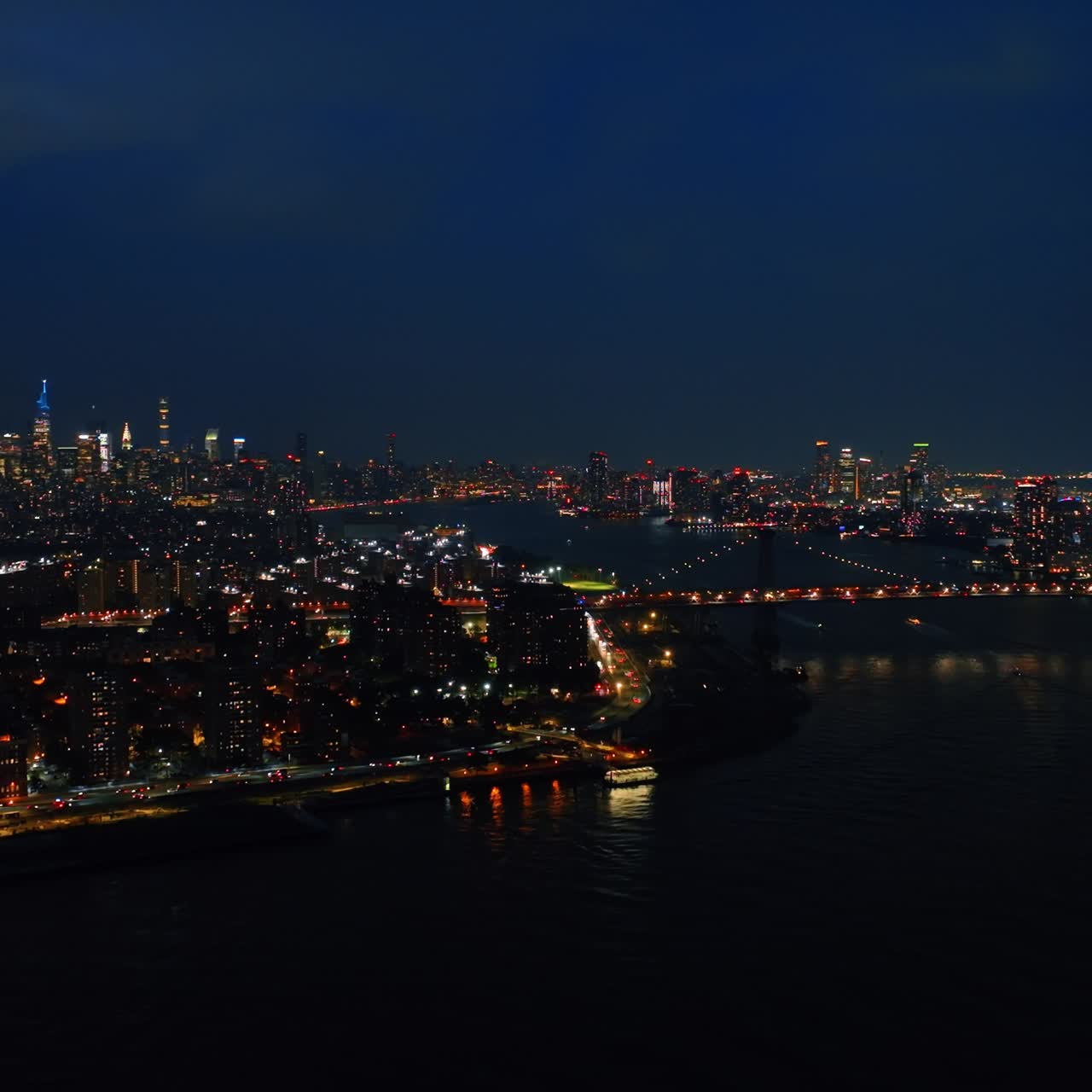 Immense cityscape of never sleeping New York. Breathtaking metropolis with lively traffic at night. Aerial view