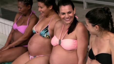 pregnant women relaxing at the poolside