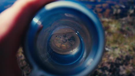 hand holding bottle of water. overhead shot