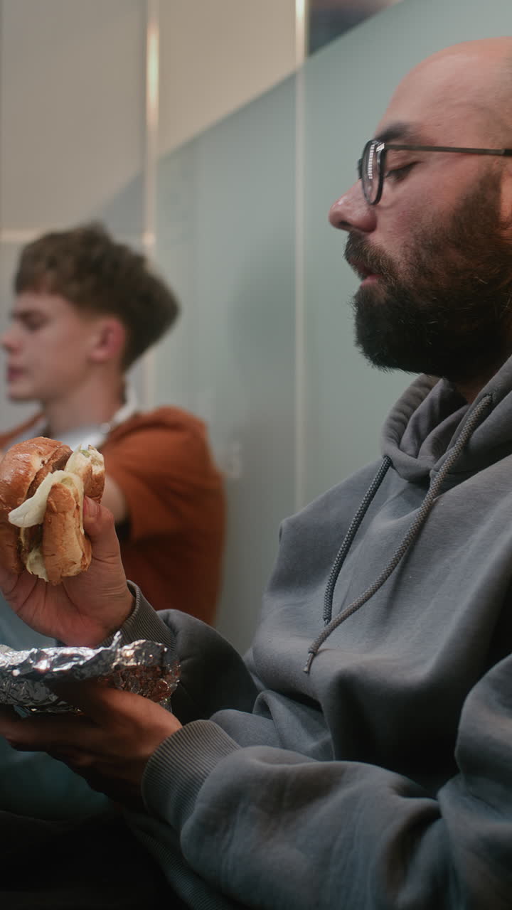Two men eating lunch in an office