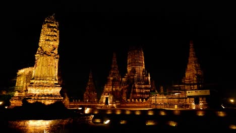 illuminated temple structures at night in ayutthaya