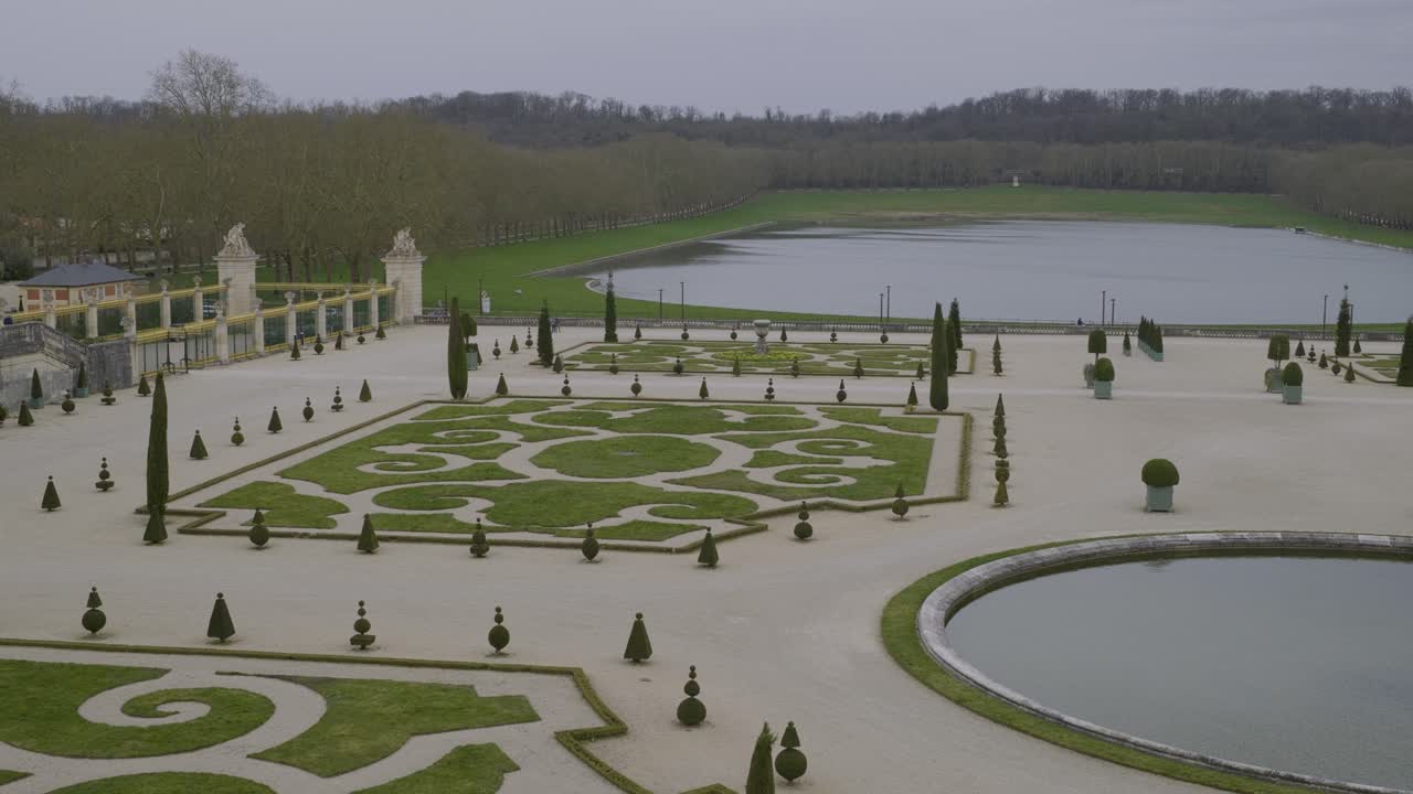 Symmetrical French garden with shaped hedges and water view, Versailles, Paris, France