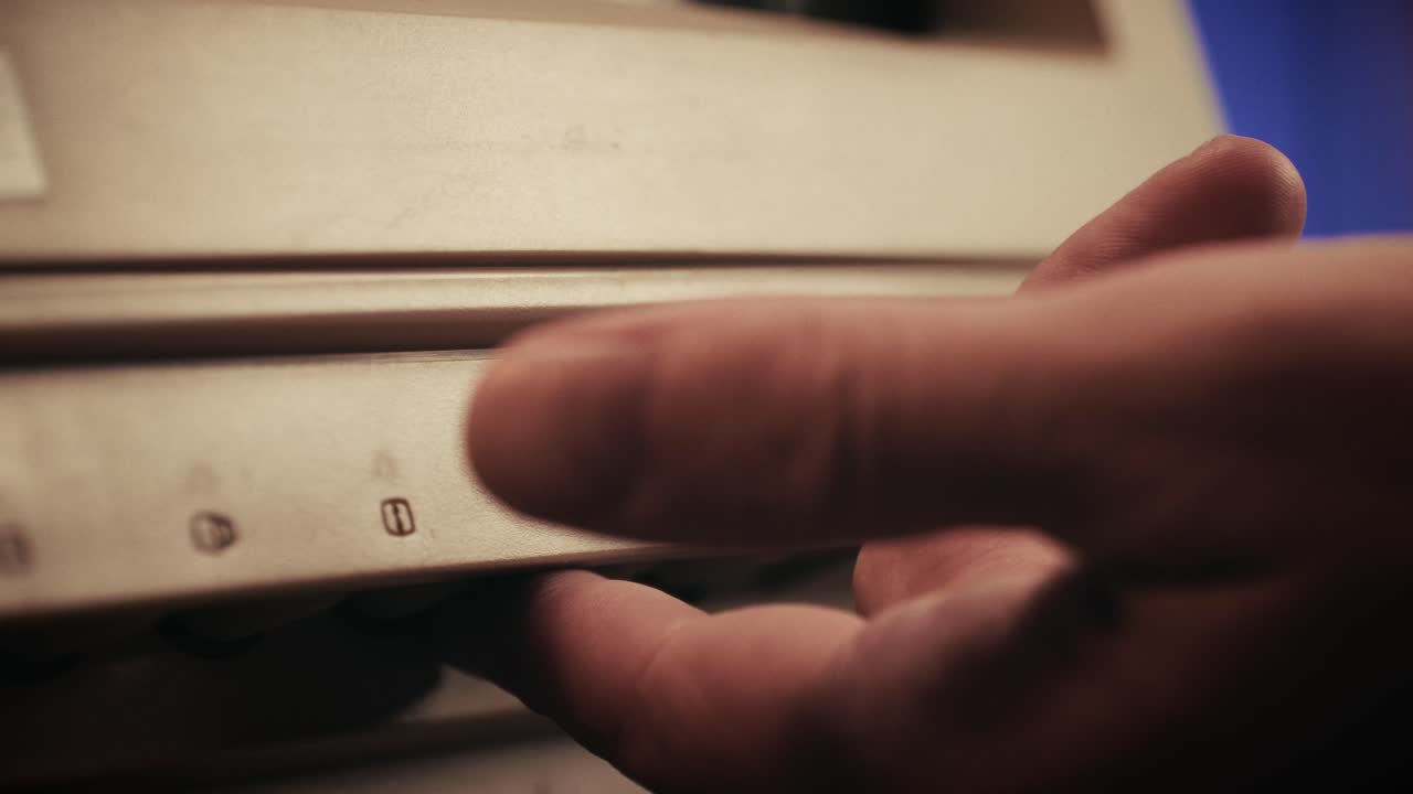 Man working and gaming on retro computer PC, IT engineer with vintage computer at home, using old fashion technology, close up of retro setup.