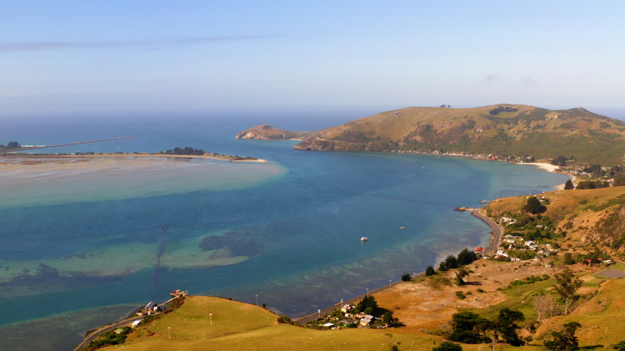 Panoramic view of a coastal bay with hills and clear waters