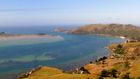 panoramic view of a coastal bay with hills and clear waters