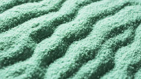 Video-of-close-up-of-green-coloured-sand-with-pattern-and-copy-space-background