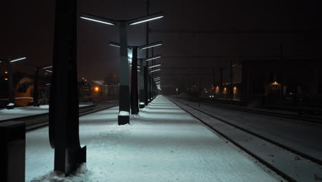 long snowy railway platform at night