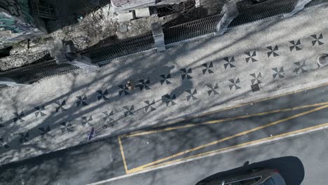aerial orbit footage showcases the charm and beauty of Lisbon&#039;s traditional Portuguese cobblestone pavement, a cultural and architectural hallmark of the city