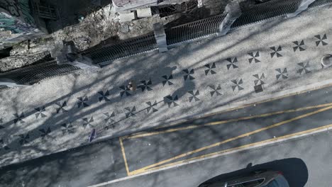 aerial orbit footage showcases the charm and beauty of lisbon's traditional portuguese cobblestone pavement, a cultural and architectural hallmark of the city