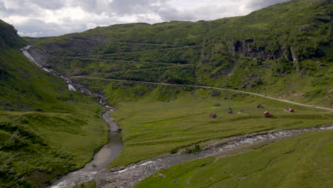 Aerial-view-of-car-driving-on-a-narrow-mountain-pass-road