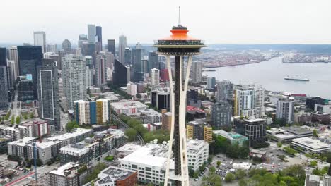 a drone fly by shot of space needle observation deck building in seattle washington, united states of america