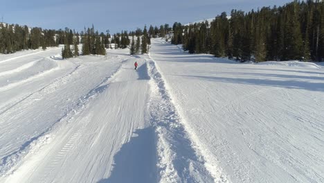 a lone skier on a snowy mountain slope