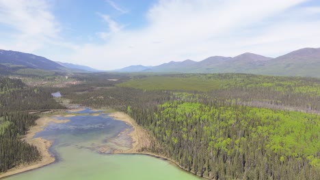 drone footage of deforestation in the canadian forest. river running next to the mountains in a village of indiginous tribes