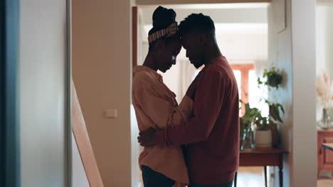 Happy,-love-and-black-couple-hug-in-home