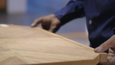 closeup shot of cabinet maker building a wood table, furniture making industry