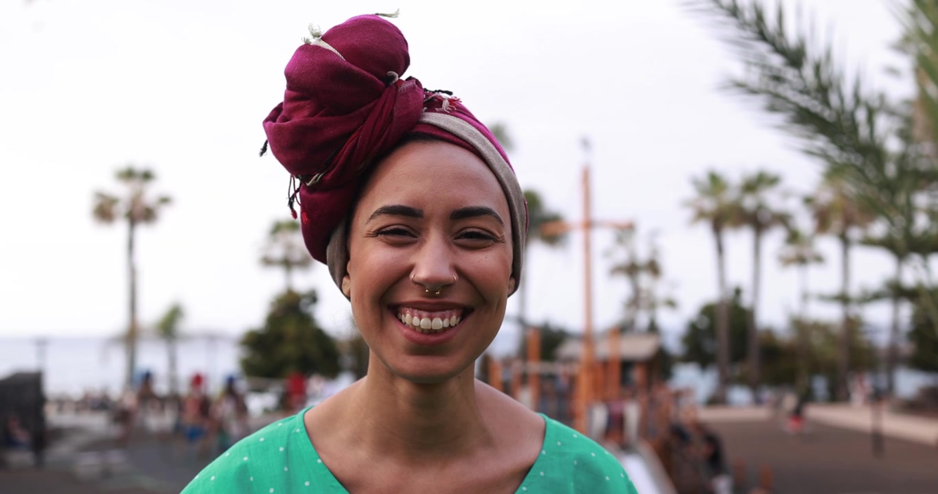 Happy Young Woman with Headscarf Smiling at Camera