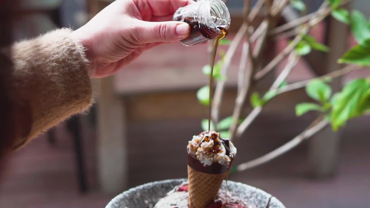 Drizzling maple syrup over pancake breakfast