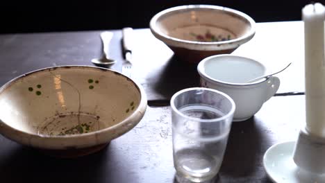 antique tableware on wooden table in handheld shot