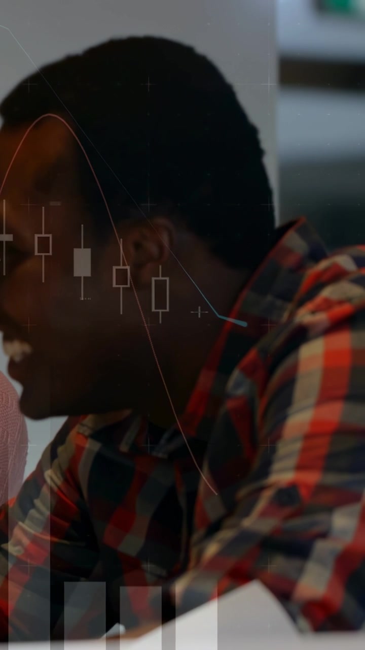 Vertical video: Man reacting to offframe prompt, speaking, laughing as market charts overlaying