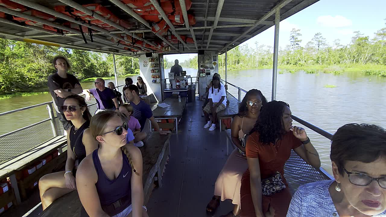 Tourists on swamp tour boat in Lousiana bayou